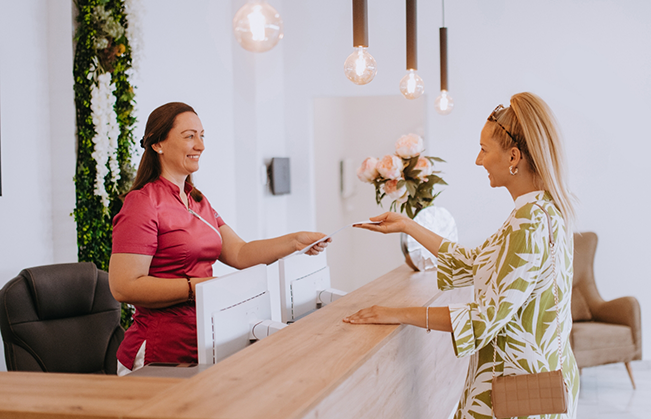 Woman checking in at the front desk