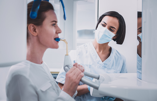 Dental patient getting a cone beam CT scan of their mouth and jaws