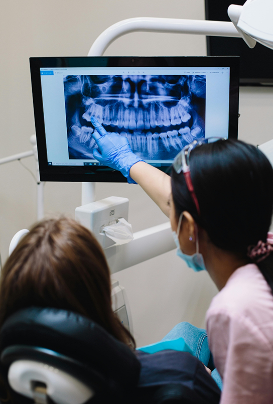 Dentist showing a patient an x ray of their teeth