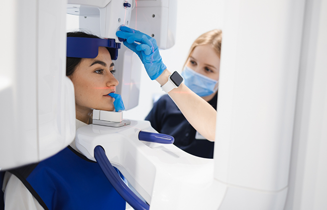 Dental patient getting a CBCT scan of her mouth and jaws