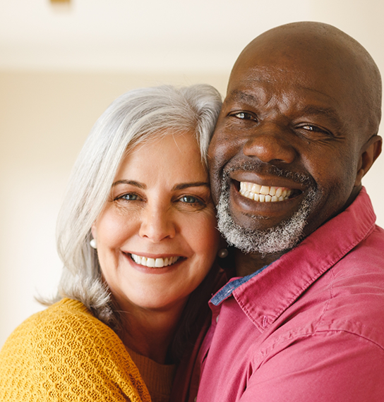 Senior couple smiling after contacting a Maple Valley dental office