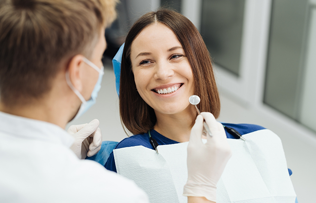 Woman grinning at her dentist during a checkup
