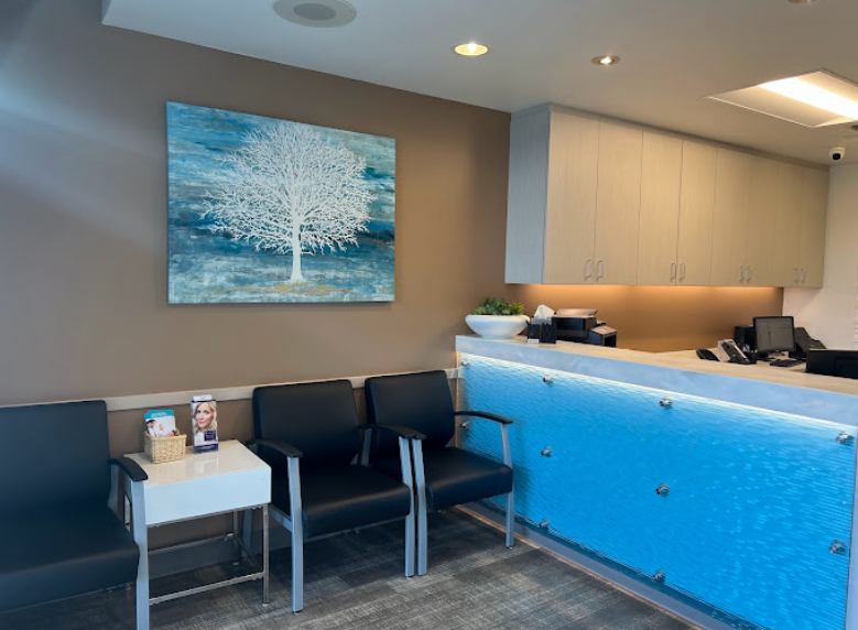 Front desk and tree artwork on the wall