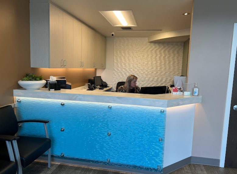 Dental team member sitting behind the front desk
