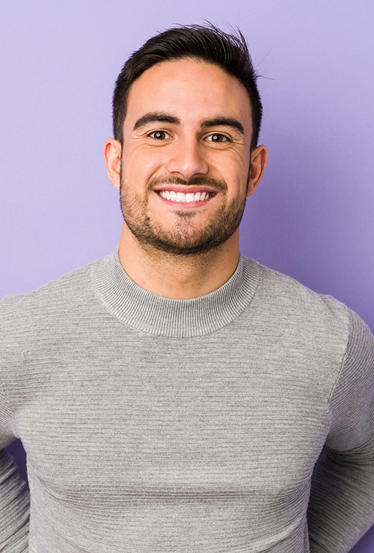 Smiling man in a gray sweater