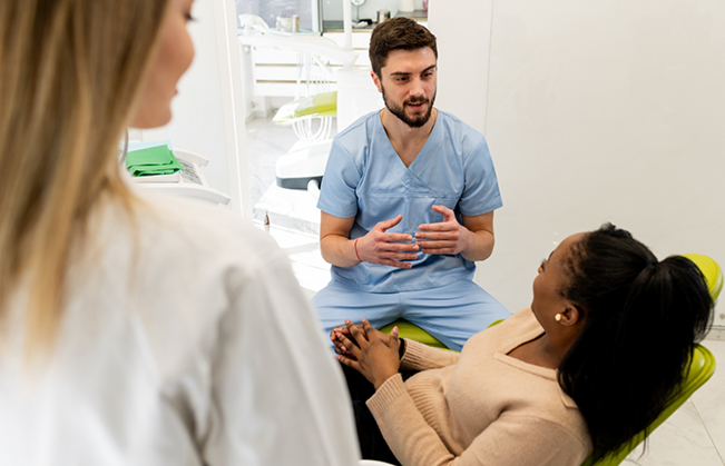 Dentist explaining root canal treatment to a patient